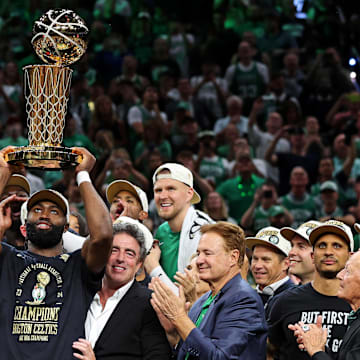Jun 17, 2024; Boston, Massachusetts, USA; Boston Celtics guard Jaylen Brown (7) celebrates with the Larry O’Brien Trophy after beating the Dallas Mavericks in game five of the 2024 NBA Finals to win the NBA Championship at TD Garden. Mandatory Credit: Peter Casey-Imagn Images