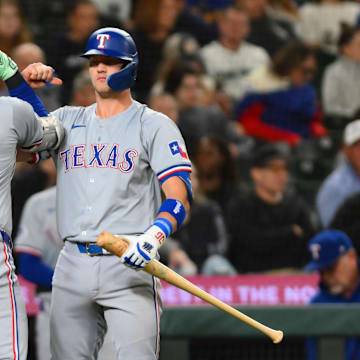 Sep 12, 2024; Seattle, Washington, USA; Texas Rangers first baseman Nathaniel Lowe (30) and third baseman Josh Jung (6) celebrate after Lowe hit a home run against the Seattle Mariners during the seventh inning at T-Mobile Park. Mandatory Credit: Steven Bisig-Imagn Images