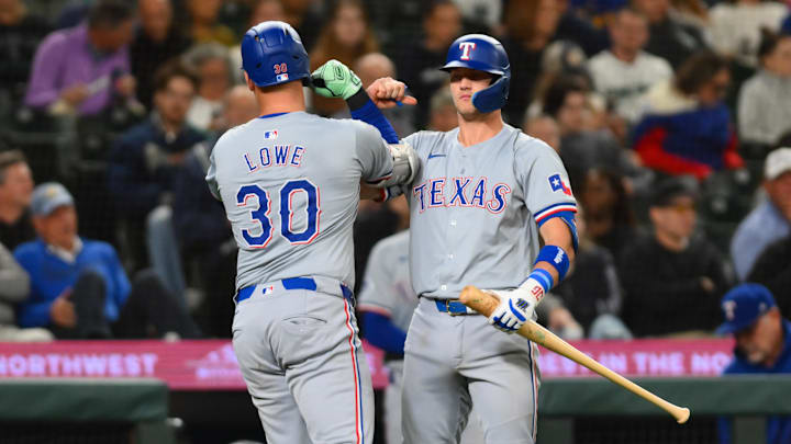 Sep 12, 2024; Seattle, Washington, USA; Texas Rangers first baseman Nathaniel Lowe (30) and third baseman Josh Jung (6) celebrate after Lowe hit a home run against the Seattle Mariners during the seventh inning at T-Mobile Park. Mandatory Credit: Steven Bisig-Imagn Images