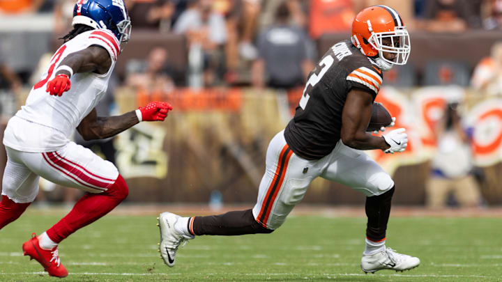 Sep 22, 2024; Cleveland, Ohio, USA; Cleveland Browns wide receiver Amari Cooper (2) runs the ball away from New York Giants cornerback Deonte Banks (3) during the fourth quarter at Huntington Bank Field. Mandatory Credit: Scott Galvin-Imagn Images