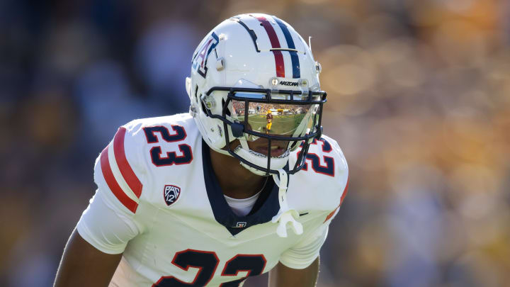 Nov 25, 2023; Tempe, Arizona, USA; An Arizona State Sun Devils player reflects in the helmet visor of Arizona Wildcats cornerback Tacario Davis (23) in the first half of the Territorial Cup at Mountain America Stadium. 