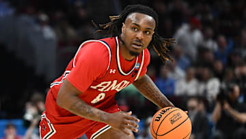 Mar 21, 2025; Cleveland, OH, USA; Robert Morris Colonials guard Kam Woods (8) dribbles in the second half against the Alabama Crimson Tide during the NCAA Tournament First Round at Rocket Arena. Mandatory Credit: Ken Blaze-Imagn Images