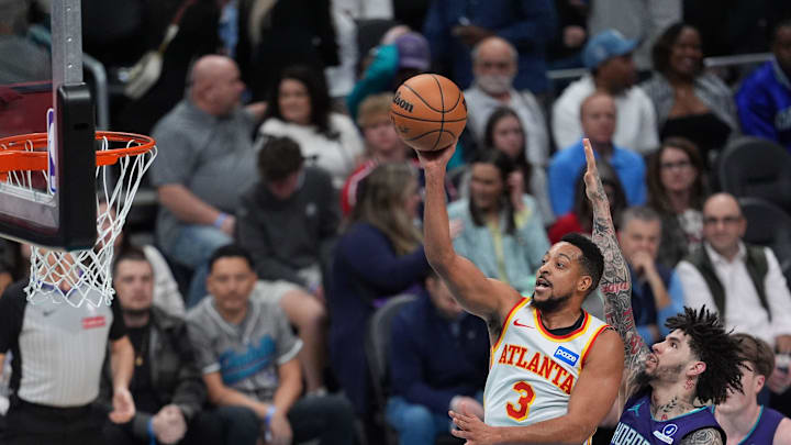 Feb 11, 2026; Charlotte, North Carolina, USA; Atlanta Hawks guard CJ McCollum (3) takes a jump shot guarded by Charlotte Hornets guard LaMelo Ball (1) during second quarter at Spectrum Center. Mandatory Credit: Jim Dedmon-Imagn Images