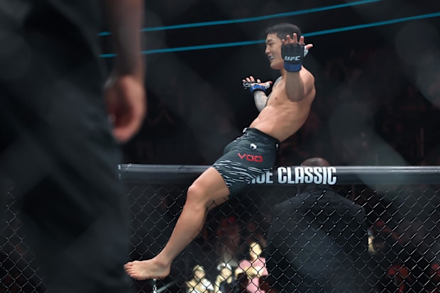 Joo Sang Yoo (blue gloves) reacts after defeating Jeka Saragih (not pictured) during UFC 316 at Prudential Center. 