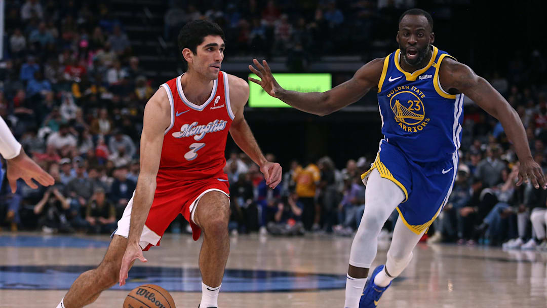 Apr 1, 2025; Memphis, Tennessee, USA; Memphis Grizzlies forward Santi Aldama (7) drives to the basket as Golden State Warriors forward Draymond Green (23) defends during the first quarter at FedExForum. Mandatory Credit: Petre Thomas-Imagn Images