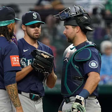 Seattle Mariners pitcher Matt Brash (47) is visited on the mound by. shortstop J.P. Crawford (3) and catcher Cal Raleigh (29) during the seventh inning against the Texas Rangers at Globe Life Field on May 3.