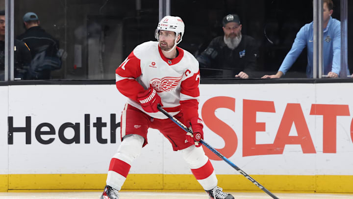 Mar 24, 2025; Salt Lake City, Utah, USA; Detroit Red Wings center Dylan Larkin (71) looks to set a play against the Utah Hockey Club during the second period at Delta Center. Mandatory Credit: Rob Gray-Imagn Images