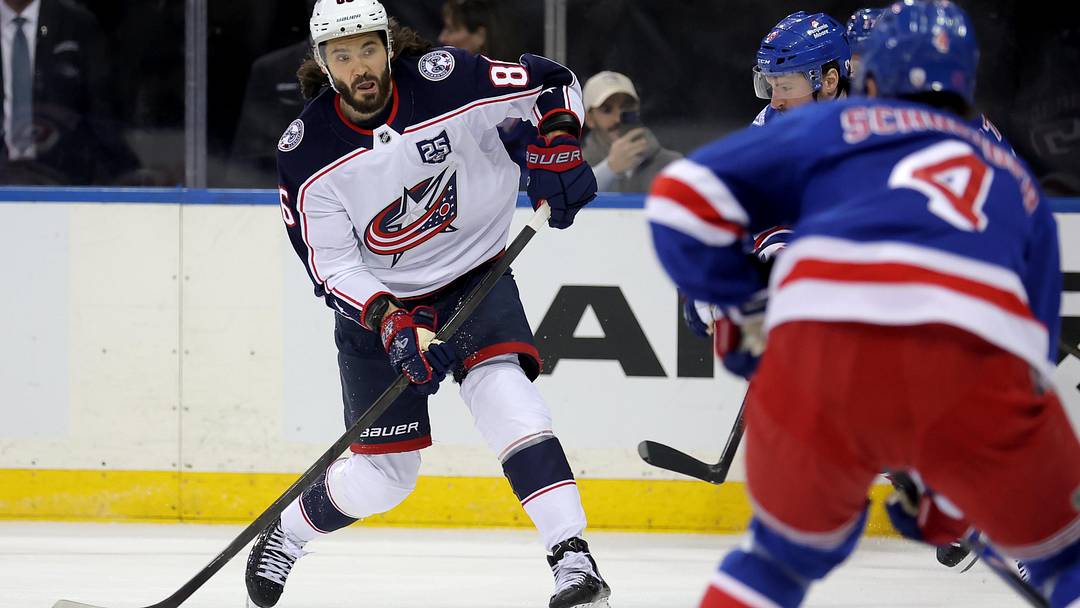 Mar 2, 2026; New York, New York, USA; Columbus Blue Jackets right wing Kirill Marchenko (86) takes a shot against New York Rangers left wing J.T. Miller (8) and defenseman Braden Schneider (4) during the first period at Madison Square Garden. Mandatory Credit: Brad Penner-Imagn Images