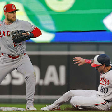 Sep 11, 2024; Minneapolis, Minnesota, USA; Los Angeles Angels second baseman Brandon Drury (23) forces out Minnesota Twins center fielder DaShawn Keirsey Jr. (89) and turns a double play in the fourth inning at Target Field. Mandatory Credit: Bruce Kluckhohn-Imagn Images