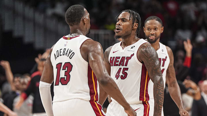 Apr 18, 2025; Atlanta, Georgia, USA; Miami Heat guard Davion Mitchell (45) reacts with center Bam Adebayo (13) after the Heat defeated the Atlanta Hawks in overtime at State Farm Arena. Mandatory Credit: Dale Zanine-Imagn Images