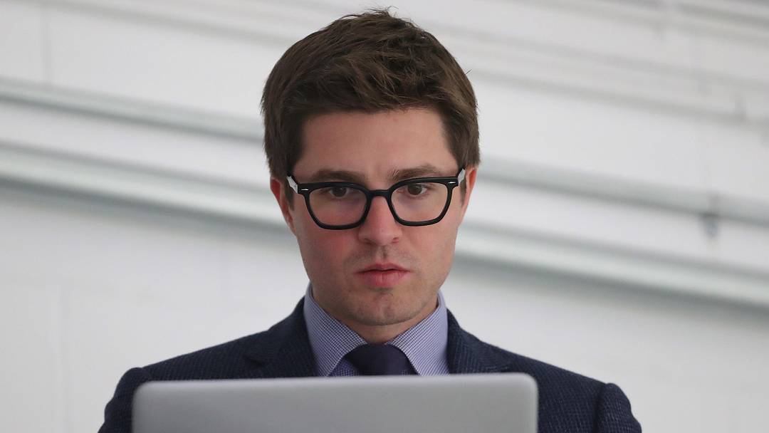 Sep 18, 2018; Lucan, Ontario, CAN; Toronto Maple Leafs general manager Kyle Dubas on his laptop before the start of their game against the Ottawa Senators at Lucan Community Memorial Centre.  The Maple Leafs beat the Senators 4-1. Mandatory Credit: Tom Szczerbowski-Imagn Images