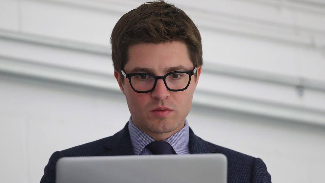 Sep 18, 2018; Lucan, Ontario, CAN; Toronto Maple Leafs general manager Kyle Dubas on his laptop before the start of their game against the Ottawa Senators at Lucan Community Memorial Centre.  The Maple Leafs beat the Senators 4-1. Mandatory Credit: Tom Szczerbowski-Imagn Images