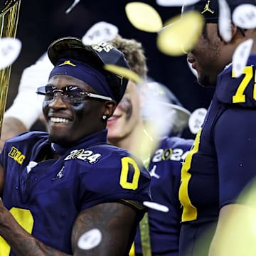 Jan 8, 2024; Houston, TX, USA; Michigan Wolverines wide receiver Darrius Clemons (0) celebrates with the CCFP National Championship trophy after beating the Washington Huskies in the 2024 College Football Playoff national championship game at NRG Stadium.