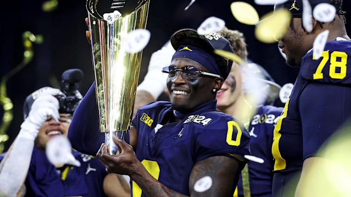 Jan 8, 2024; Houston, TX, USA; Michigan Wolverines wide receiver Darrius Clemons (0) celebrates with the CCFP National Championship trophy after beating the Washington Huskies in the 2024 College Football Playoff national championship game at NRG Stadium.