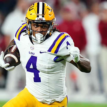 Nov 4, 2023; Tuscaloosa, Alabama, USA; LSU Tigers running back John Emery Jr. (4) carries the ball against the Alabama Crimson Tide during the second quarter at Bryant-Denny Stadium. Mandatory Credit: John David Mercer-Imagn Images