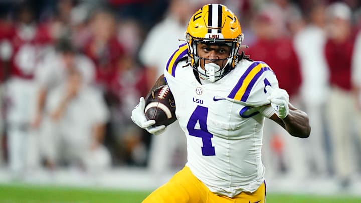 Nov 4, 2023; Tuscaloosa, Alabama, USA; LSU Tigers running back John Emery Jr. (4) carries the ball against the Alabama Crimson Tide during the second quarter at Bryant-Denny Stadium. Mandatory Credit: John David Mercer-Imagn Images