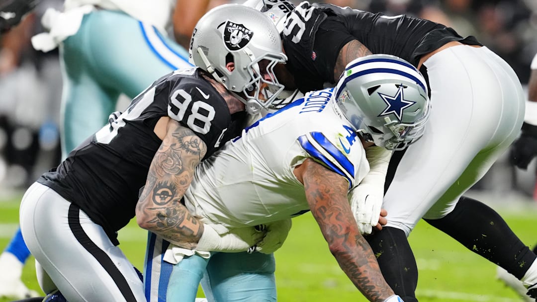 Nov 17, 2025; Paradise, Nevada, USA;  Las Vegas Raiders defensive end Maxx Crosby (98) takes down Dallas Cowboys quarterback Dak Prescott (4) after forcing a fumble during the first half at Allegiant Stadium.
