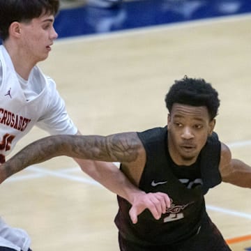 Peoria High's Anthony Sturdivant III (4) moves the ball against Chicago Brother Rice's Max Justice in the first half of the Class 3A boys basketball Pontiac Super-Sectional on Monday, March 10, 2025 at Pontiac Township High School. The Lions fell 60-41.
