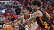 Feb 8, 2025; Louisville, Kentucky, USA;  Miami (Fl) Hurricanes guard Matthew Cleveland (0) drives to the basket against Louisville Cardinals guard J'Vonne Hadley (1) during the first half at KFC Yum! Center. Louisville defeated Miami 88-78. Mandatory Credit: Jamie Rhodes-Imagn Images