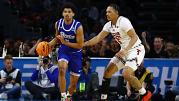 Mar 22, 2025; Wichita, KS, USA; Drake Bulldogs guard Kael Combs (11) dribbles the ball against Texas Tech Red Raiders forward Darrion Williams (5) during the first half at Intrust Bank Arena. Mandatory Credit: Nick Tre. Smith-Imagn Images
