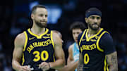 Mar 29, 2024; Charlotte, North Carolina, USA; Golden State Warriors guards Stephen Curry (30) and Gary Payton II look to the bench during a break in the action against the Charlotte Hornets during the first quarter at Spectrum Center. Mandatory Credit: Nell Redmond-Imagn Images