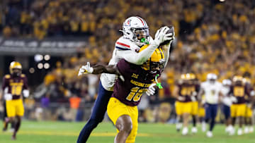 Nov 28, 2025; Tempe, Arizona, USA; Arizona Wildcats defensive back Treydan Stukes (2) intercepts the ball against Arizona State Sun Devils wide receiver Jaren Hamilton (16) in the second half during the 99th Territorial Cup at Mountain America Stadium. Mandatory Credit: Mark J. Rebilas-Imagn Images