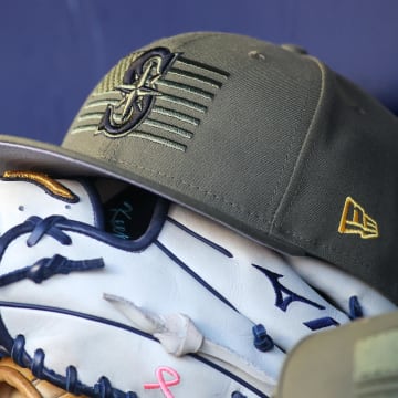 A detailed view of the Seattle Mariners armed forces day hat is seen in the dugout before a game against the Atlanta Braves.
