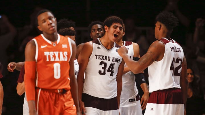 Nov 25, 2015; Paradise Island, BAHAMAS; Texas A&M Aggies center Tyler Davis (34) celebrates with teammates in front of Texas Longhorns guard Tevin Mack (0) after the game during the 2015 Battle 4 Atlantis in the Imperial Arena at the Atlantis Resort.. Mandatory Credit: Kevin Jairaj-USA TODAY Sports