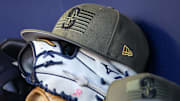 A Seattle Mariners Armed Forces Day hat is pictured in the dugout before a game against the Atlanta Braves on May 20, 2023, at Truist Park.