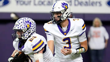 Nevada quarterback Drake Hinson (3) hands the ball off to Nevada running back Austin Waldera (21) Nov. 15, 2025 during a Class 3A Iowa high school football semifinal at the UNI-Dome in Cedar Falls, Iowa.