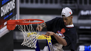 Mar 14, 2021; Indianapolis, Indiana, USA; Illinois Fighting Illini guard Adam Miller (44) cuts down a piece of the net after defeating the Ohio State Buckeyes at Lucas Oil Stadium. Mandatory Credit: Aaron Doster-Imagn Images
