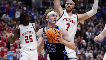 Mar 22, 2025; Denver, CO, USA; Brigham Young Cougars forward Richie Saunders (15) grabs a rebound against the Wisconsin Badgers during the first half in the first round of the NCAA Tournament  at Ball Arena. Mandatory Credit: Ron Chenoy-Imagn Images