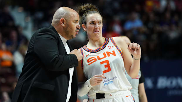 Connecticut Sun head coach Rachid Meziane talks with guard Marina Mabrey on the sidelines