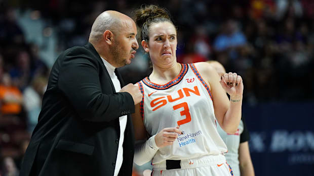 Connecticut Sun head coach Rachid Meziane talks with guard Marina Mabrey during a game
