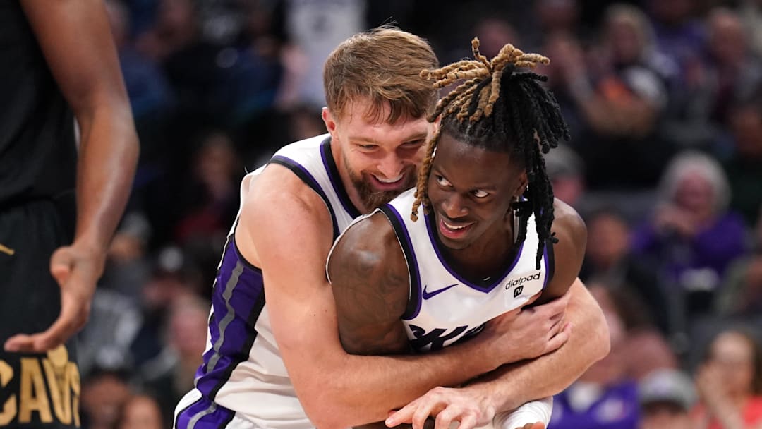 Nov 13, 2023; Sacramento, California, USA; Sacramento Kings forward Domantas Sabonis (10) hugs guard Keon Ellis (23) after Sabonis made a basket while being fouled against the Cleveland Cavaliers in the fourth quarter at the Golden 1 Center.