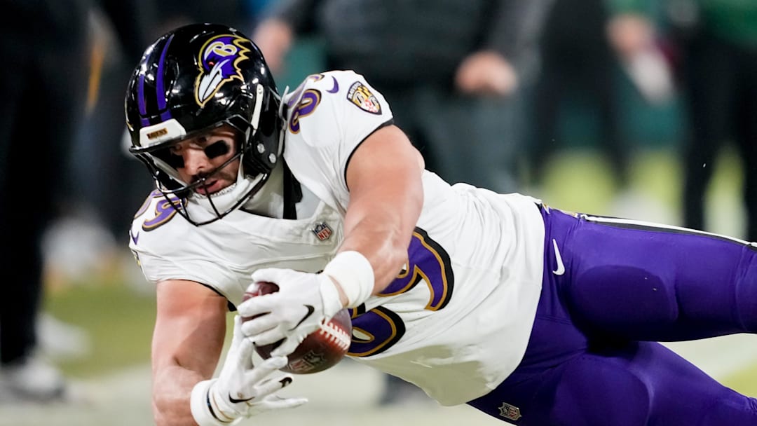 Dec 27, 2025; Green Bay, Wisconsin, USA; Baltimore Ravens tight end Mark Andrews (89) stretches the ball for a first down during the first quarter against the Green Bay Packers at Lambeau Field. Mandatory Credit: Kayla Wolf-Imagn Images