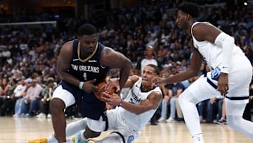 Oct 25, 2023; Memphis, Tennessee, USA; New Orleans Pelicans forward Zion Williamson (1) looses control of the ball as Memphis Grizzlies guard Desmond Bane (22) and forward-center Jaren Jackson Jr. (13) defends during the second half at FedExForum. Mandatory Credit: Petre Thomas-Imagn Images