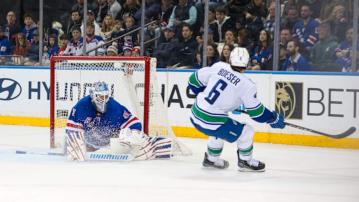 Mar 22, 2025; New York, New York, USA; New York Rangers goalie Igor Shesterkin (31) makes a save on Vancouver Canucks right wing Brock Boeser (6) during the second period at Madison Square Garden. Mandatory Credit: Danny Wild-Imagn Images