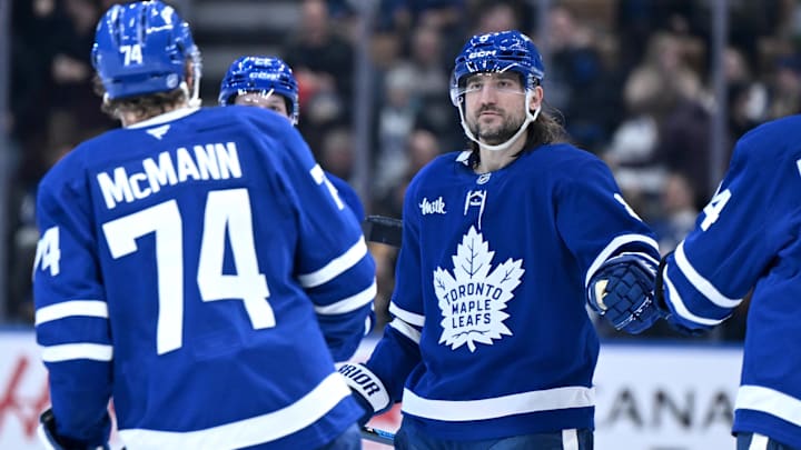 Dec 23, 2025; Toronto, Ontario, CAN;  Toronto Maple Leafs defenseman Chris Tanev (8) greets forward Bobby McMann who scored an empty net goal against the Pittsburgh Penguins in the third period at Scotiabank Arena. Mandatory Credit: Dan Hamilton-Imagn Images