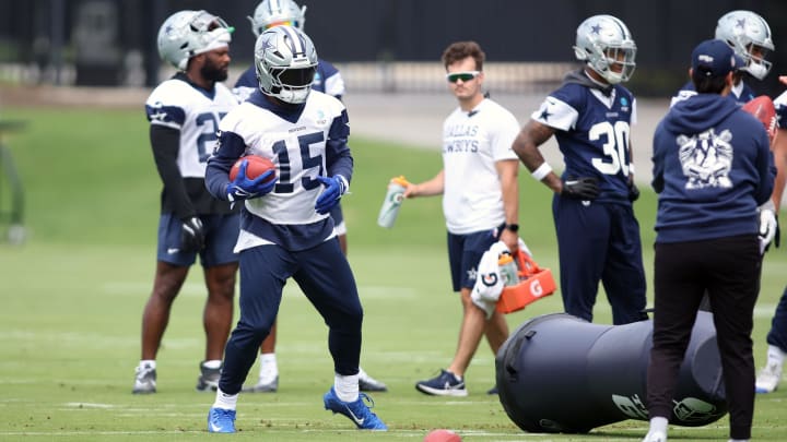 Jun 4, 2024; Frisco, TX, USA; Dallas Cowboys running back Ezekiel Elliott (15) goes through a drill during practice at the Ford Center at the Star Training Facility in Frisco, Texas. 