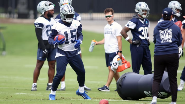 Jun 4, 2024; Frisco, TX, USA; Dallas Cowboys running back Ezekiel Elliott (15) goes through a drill during practice at the Ford Center at the Star Training Facility in Frisco, Texas. 