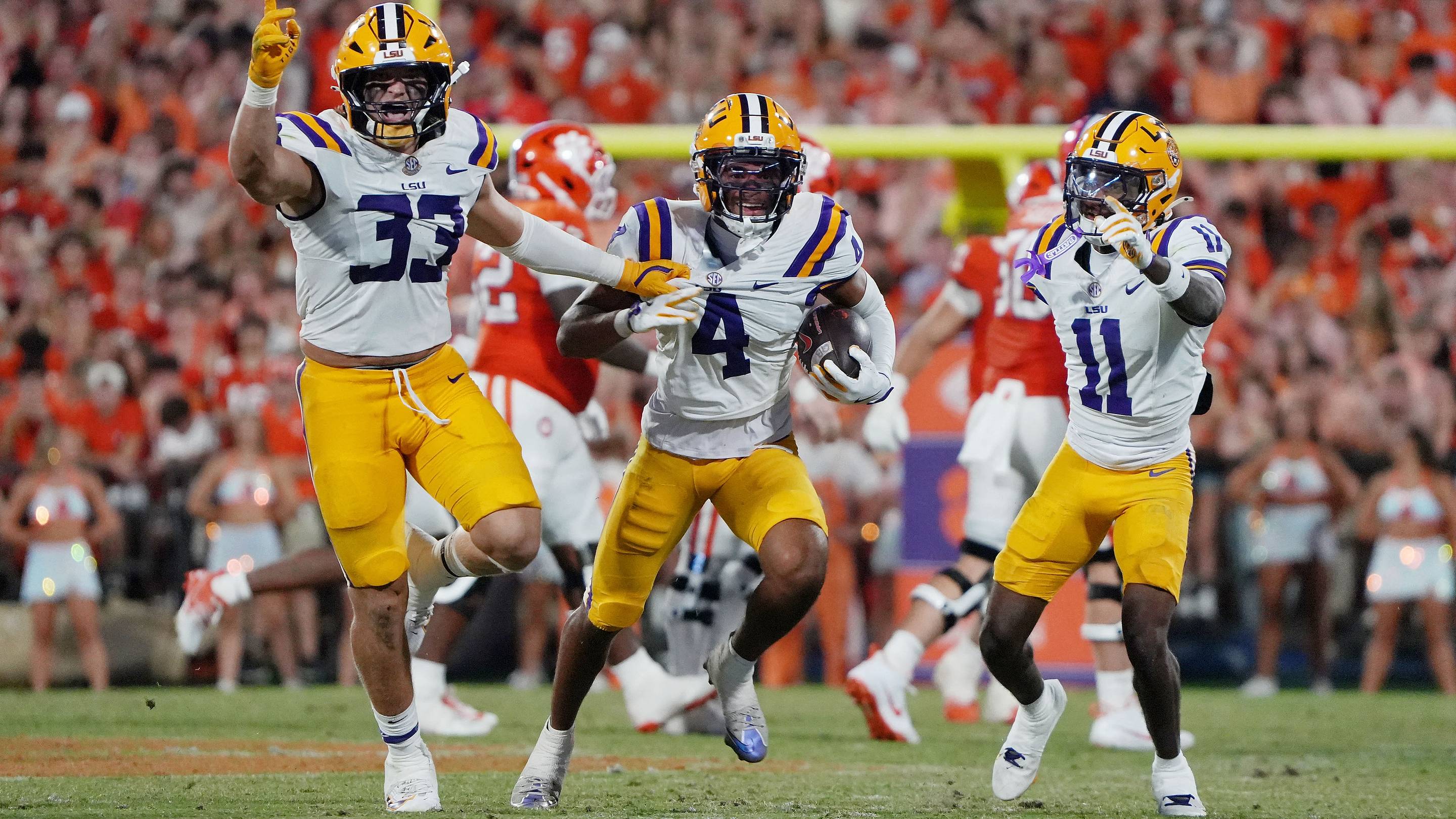 West Weeks, PJ Woodland and Mansoor Delane celebrate after a play against Clemson in 2025