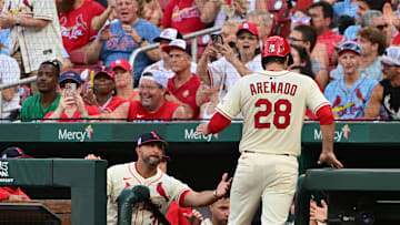 Jul 26, 2025; St. Louis, Missouri, USA; St. Louis Cardinals manager Oliver Marmol (37, left in dugout) congratulates St. Louis Cardinals third baseman Nolan Arenado (28) after he scored in the second inning against the San Diego Padres at Busch Stadium. Mandatory Credit: Tim Vizer-Imagn Images