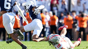 Ohio State Buckeyes QB Will Howard tackles Penn State Nittany Lions CB A.J. Harris during the second half of the NCAA football game at Beaver Stadium.