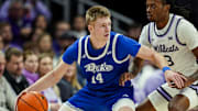 Dec 17, 2024; Kansas City, Missouri, USA; Drake Bulldogs guard Bennett Stirtz (14) dribbles the ball against Kansas State Wildcats guard C.J. Jones (3) at T-Mobile Center. Mandatory Credit: Jay Biggerstaff-Imagn Images
