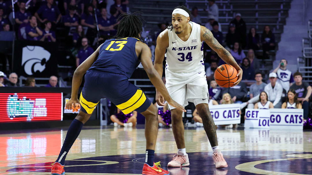 Mar 3, 2026; Manhattan, Kansas, USA; Kansas State Wildcats guard Nate Johnson (34) dribbles against West Virginia Mountaineers guard Chance Moore (13) during the second half at Bramlage Coliseum. Mar 3, 2026; Manhattan, Kansas, USA; Kansas State Wildcats guard Nate Johnson (34) dribbles against West Virginia Mountaineers guard Chance Moore (13) during the second half at Bramlage Coliseum.