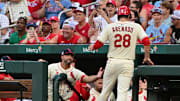 Jul 26, 2025; St. Louis, Missouri, USA; St. Louis Cardinals manager Oliver Marmol (37, left in dugout) congratulates St. Louis Cardinals third baseman Nolan Arenado (28) after he scored in the second inning against the San Diego Padres at Busch Stadium. Mandatory Credit: Tim Vizer-Imagn Images