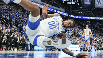 Arkansas Razorbacks forward Karter Knox (11) slams down two as Kentucky Wildcats guard Otega Oweh (00) falls to the ground in the Wildcats' 89-79 loss to the Hogs Saturday Feb. 1, 2025 at Rupp Arena in Lexington, Kentucky.