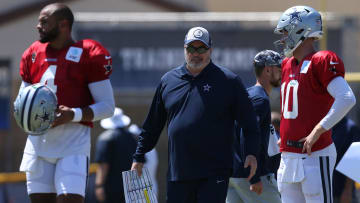 Jul 31, 2024; Oxnard, CA, USA; Dallas Cowboys head coach Mike McCarthy talks to quarterback Dak Prescott (4) and quarterback Cooper Rush (10) during training camp at the River Ridge Playing Fields in Oxnard, California.  Mandatory Credit: Jason Parkhurst-USA TODAY Sports
