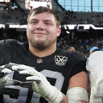 Jan 5, 2025; Paradise, Nevada, USA; Oregon Ducks former players (from left) Las Vegas Raiders guard Jackson Powers-Johnson (58) and Los Angeles Chargers linebacker Troy Dye (43) and quarterback Justin Herbert (10) pose after the game at Allegiant Stadium. Mandatory Credit: Kirby Lee-Imagn Images